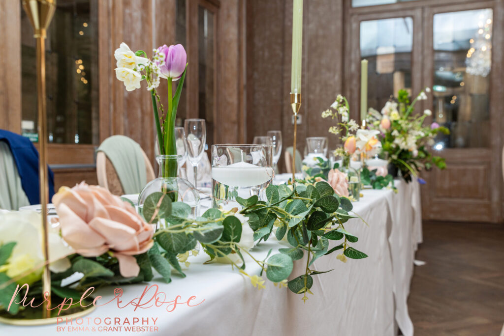 Photo of wedding breakfast table decorated wit flowers and glass wear for a wedding in Northampton