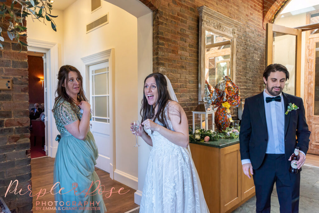 Photo of a bride laughing with a friend at her wedding in Northampton