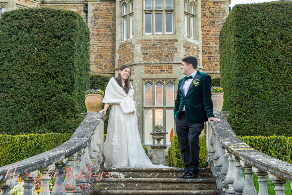 Photo of a bride and groom on a staircase outside their wedding venue in Northampton