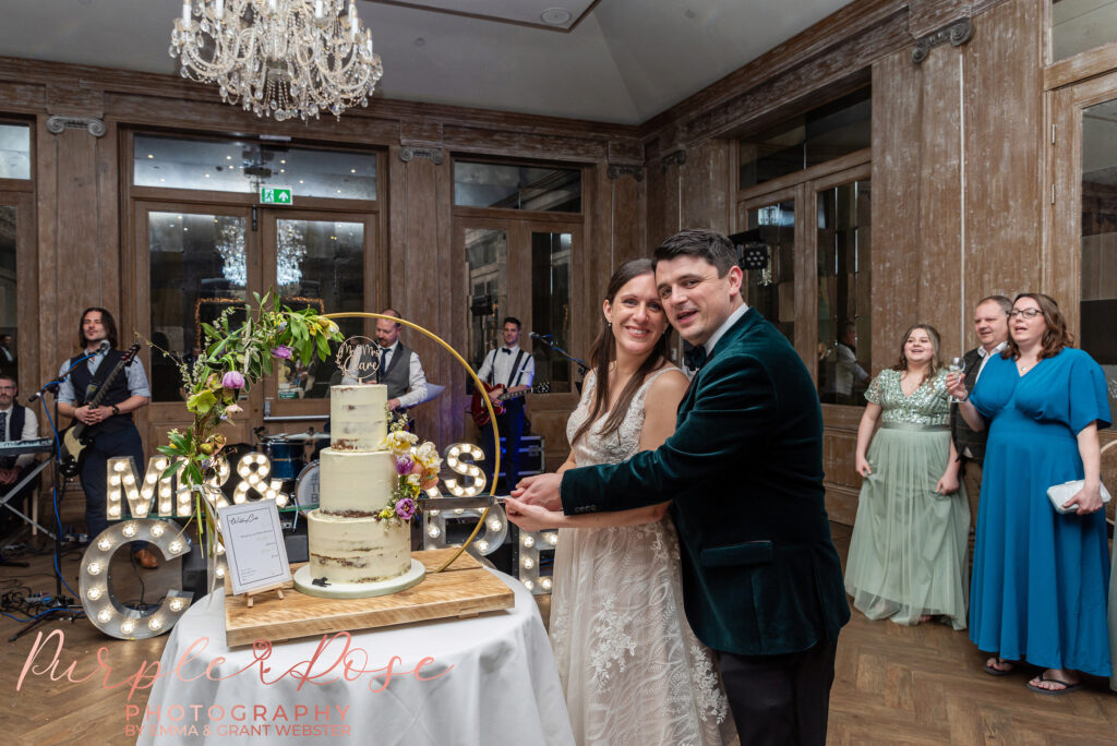 Photo of a bride and groom cutting their wedding cake in Northampton