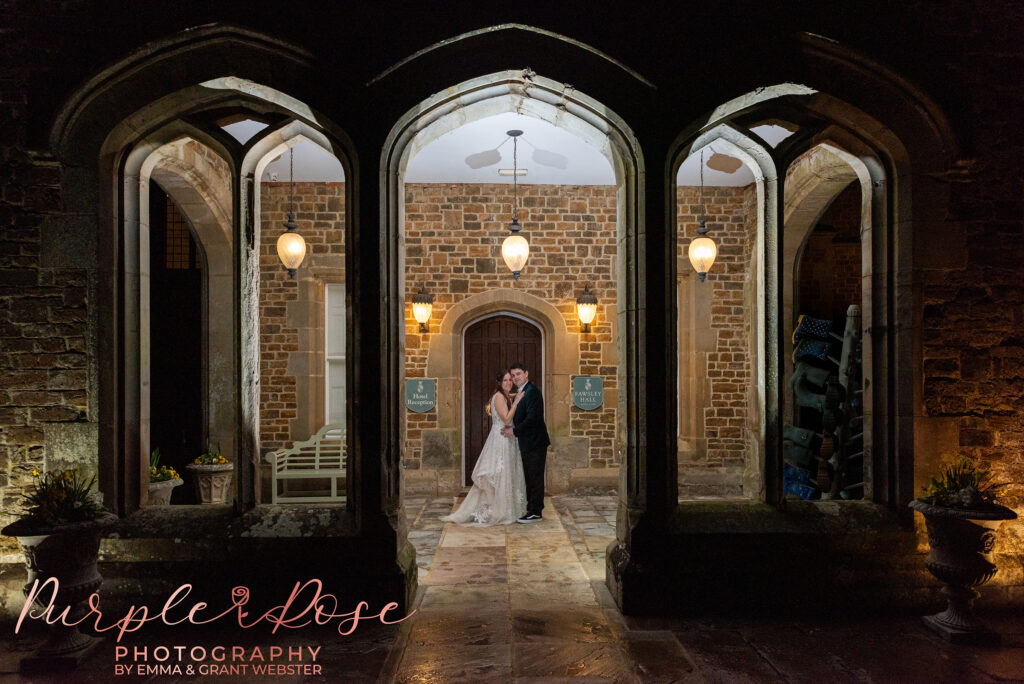 Photo of a bride and groom at night-time outside their wedding venue in Northampton