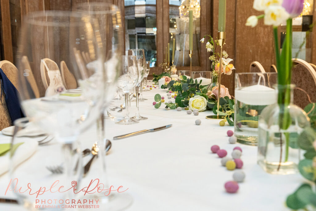 Photo of flowers and glass wear on a table at a wedding in Northampton