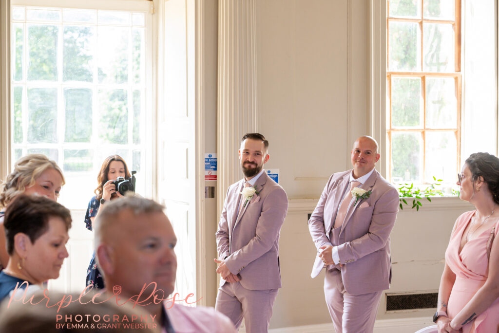 Groom looking towards the grand staircase at Chicheley Hall as he awaits his brides arrival