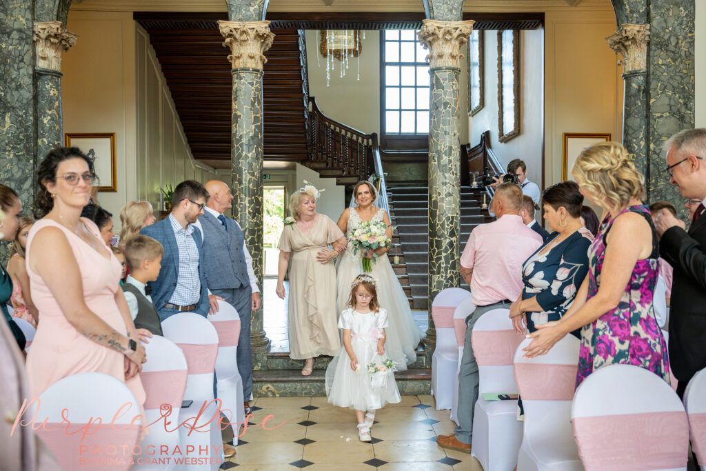 Bride smiling as she arrives at her wedding ceremony at Chicheley Hall in Milton Keynes