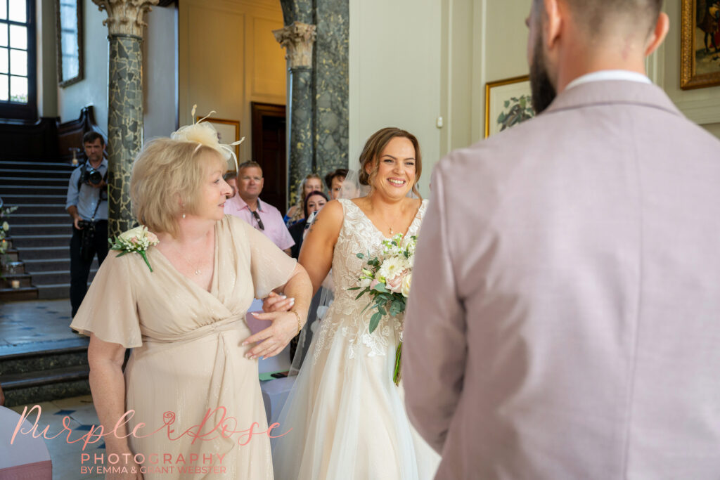 Brides smiling as she see hers husband on their wedding day at Chicheley Hall in Milton Keynes