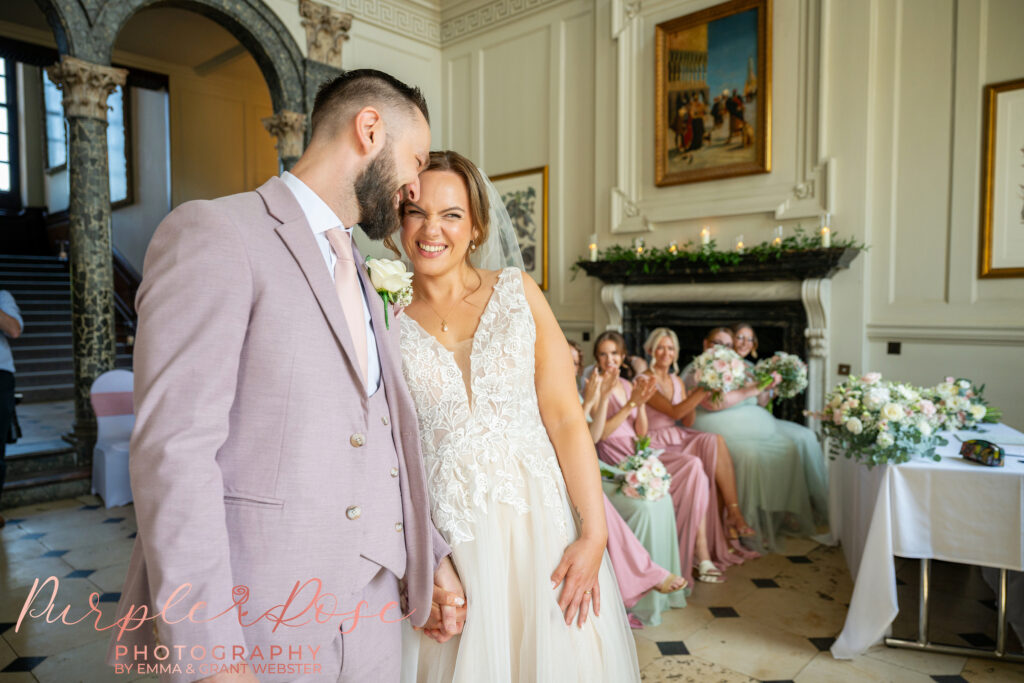 Photo of a bride smiling during her wedding ceremony at Chicheley Hall