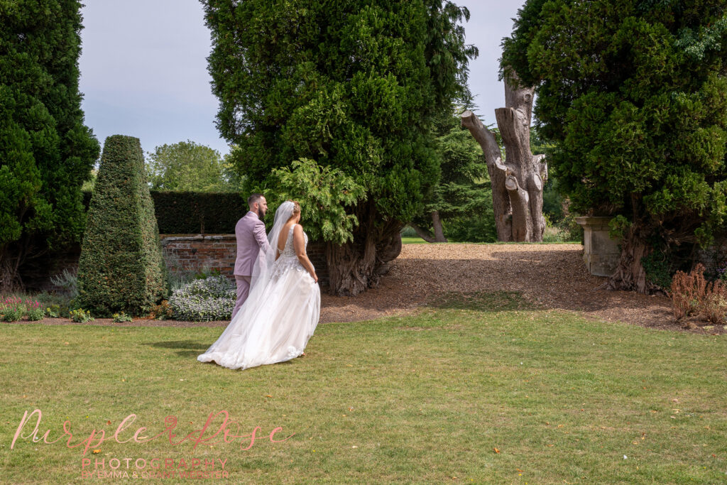 Photo of a bride and groom walking away on their wedding day at Chicheley Hall Milton Keynes
