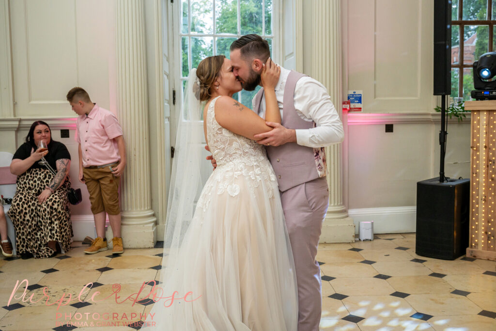 Bride and groom kissing during their first dance at Chicheley Hall in Milton Keynes
