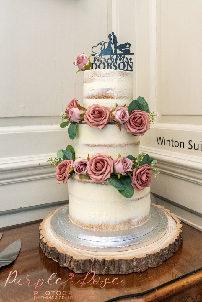 Photo of a wedding cake with blush flowers ready for a wedding at Chicheley Hall Milton Keynes