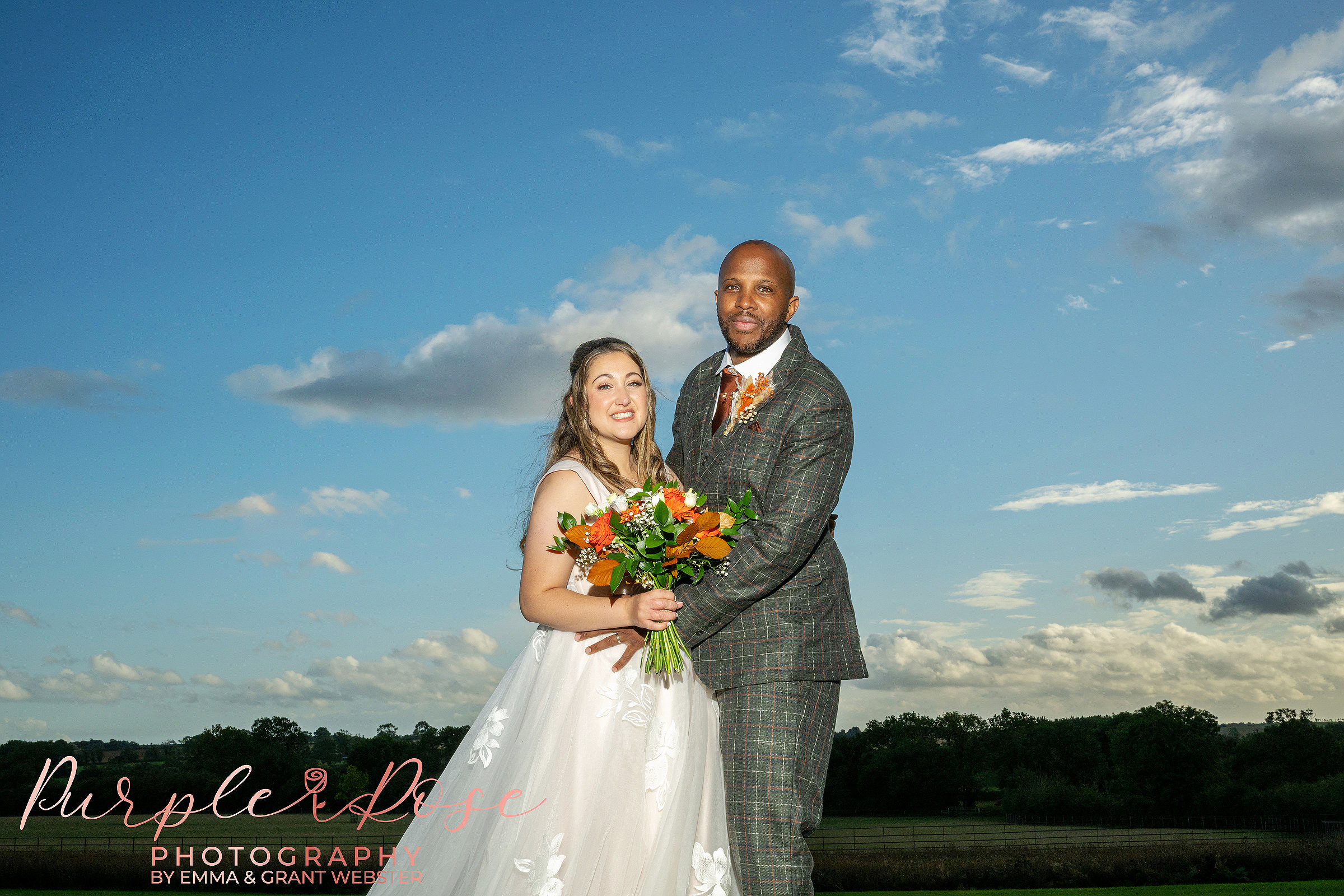 Photo of a bride and groom in front of a stunning sky at Crockwell Farm on their wedding day