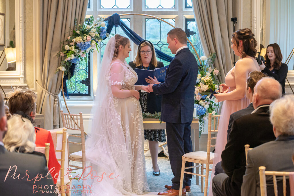 Bride and groom being marred by a registrar at their wedding in Milton Keynes
