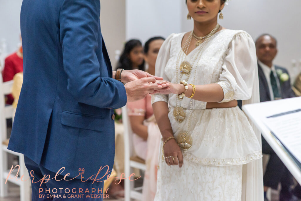 Bride and groom exchanging rings during their wedding ceremony at Milton Keynes Registry Office