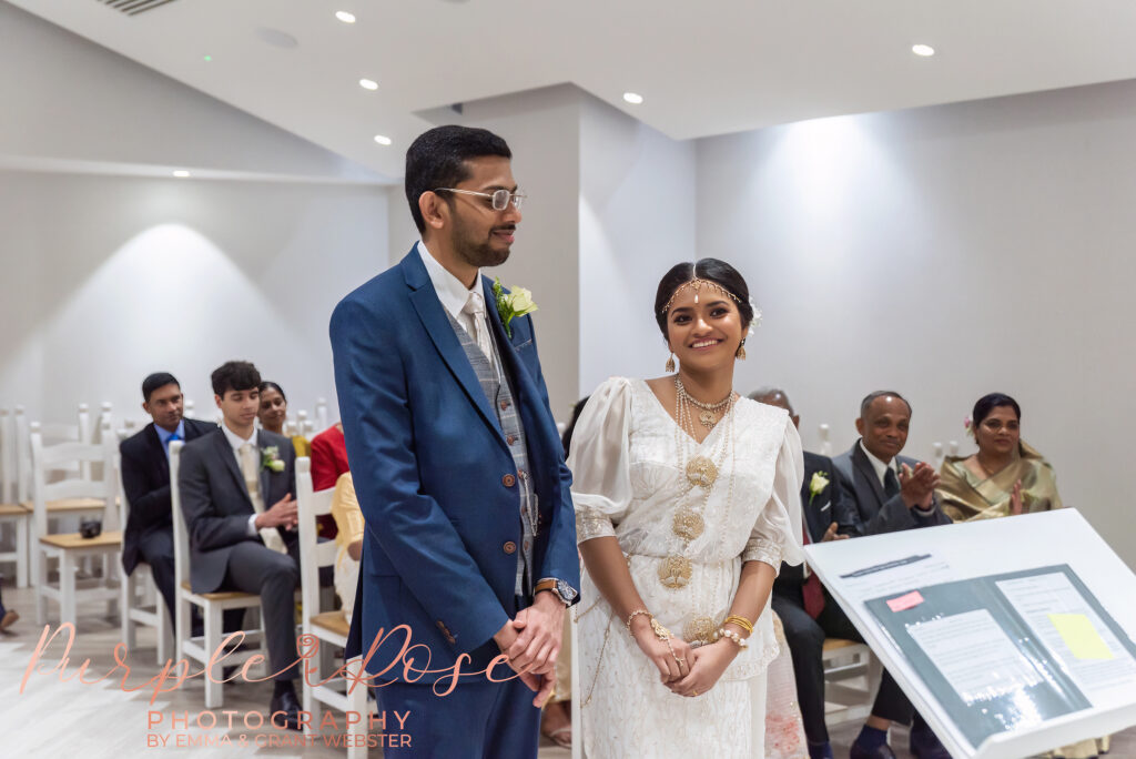 Bride and groom laughing during their wedding ceremony at Milton Keynes Registry Office