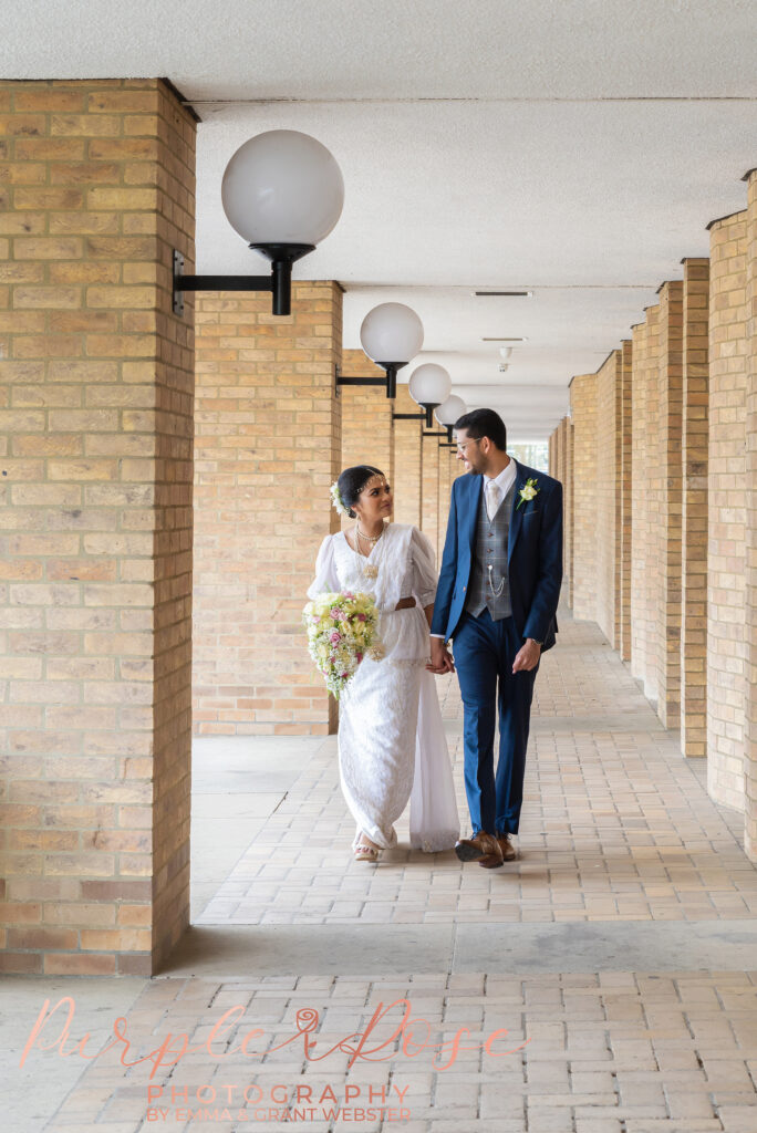 Bride and groom walking outside Milton Keynes Registry Office