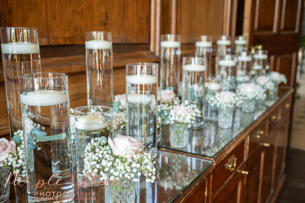 Photo of floating candles and table decorations waiting to be placed at a wedding at Chicheley Hall