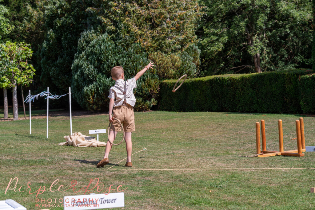 Boy playing garden games at a wedding at Chicheley Hall Milton Keynes