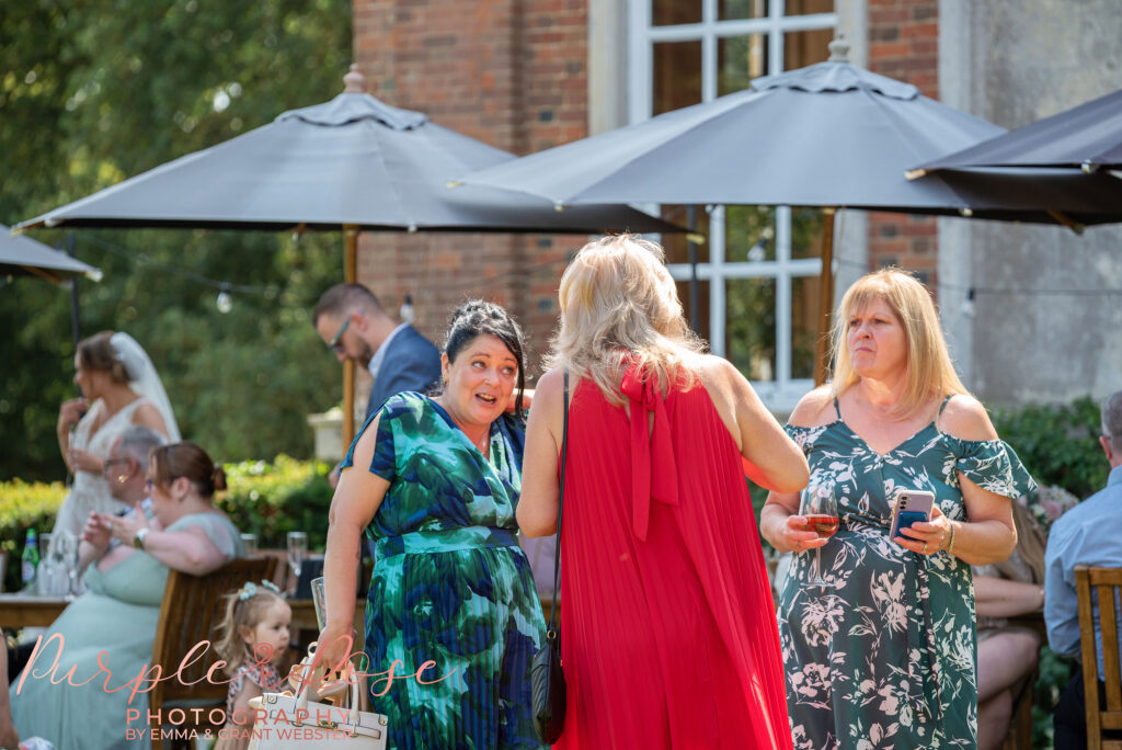 Wedding guests enjoying the gardens at Chicheley Hall Milton Keynes