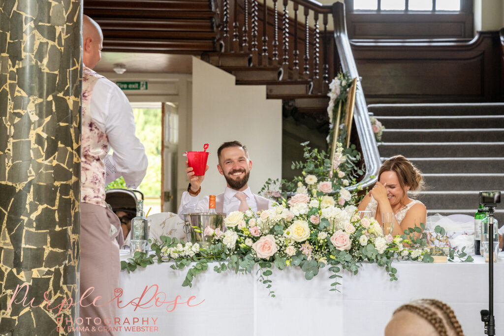 Groom laughing during his best mans speech