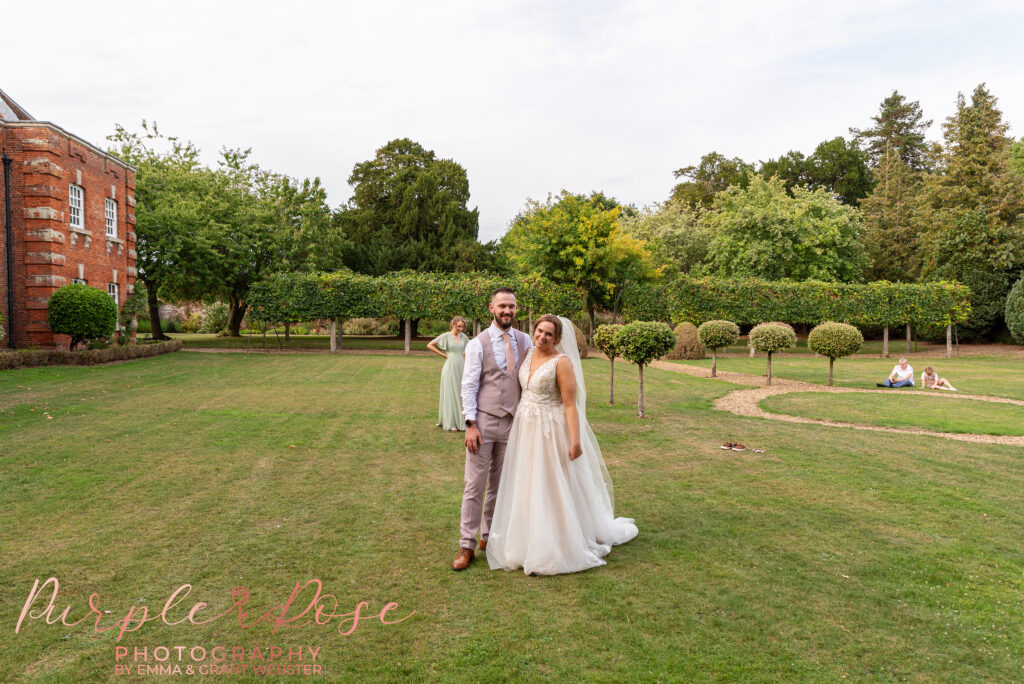 Bride and groom stood in the grounds at Chicheley Hall in Milton Keynes