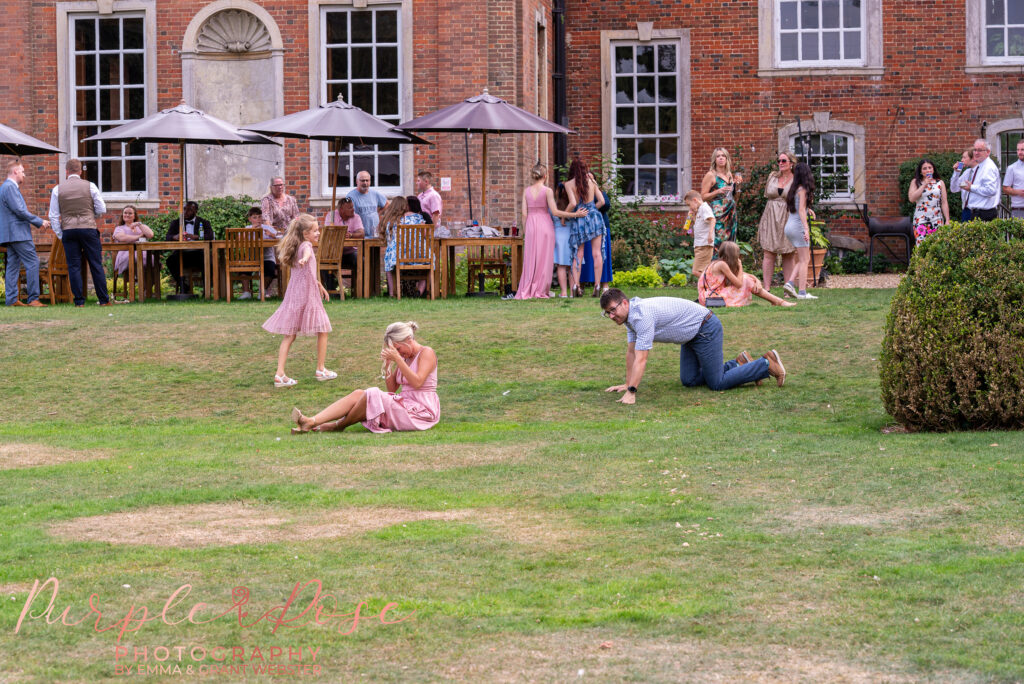 Wedding guests relaxing in the gardens of Chicheley Hall in Milton Keynes