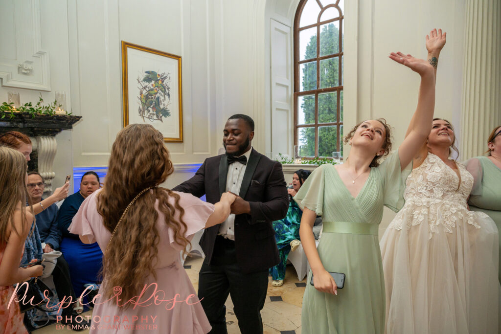 Wedding guests dancing at a wedding at Chicheley Hall in Milton Keynes