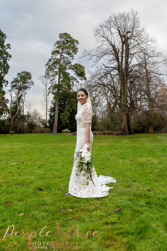 Bride stood in the grounds of her wedding venue in Northampton