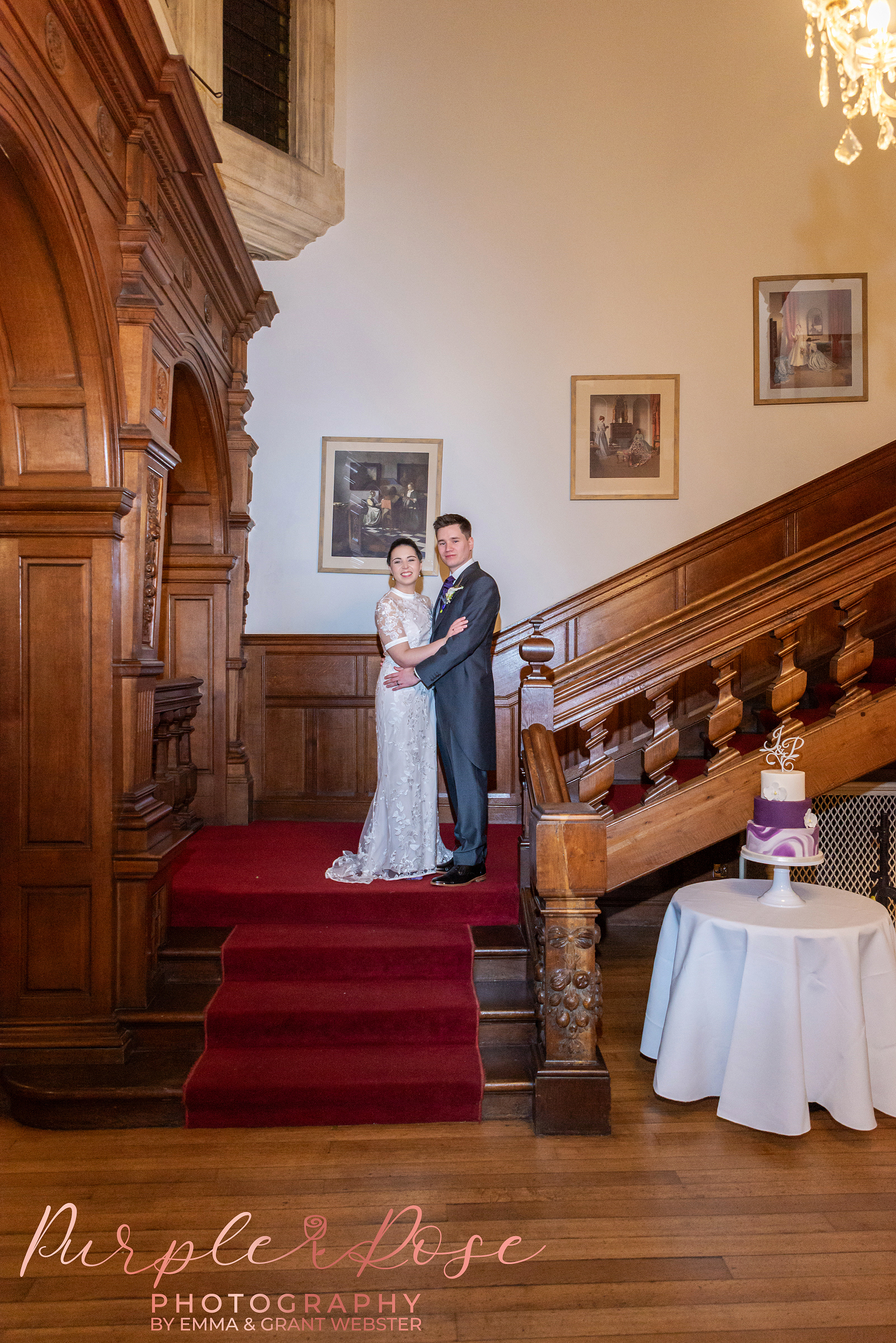 Photo of a bride and groom stood on the stairs at Holmewood Hall Peterborough