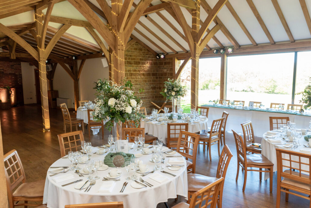 Dodford manor set up for a wedding breakfast with a sage green and white theme