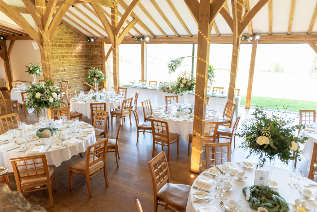 Dodford manor set up for a wedding breakfast with a sage green and white theme