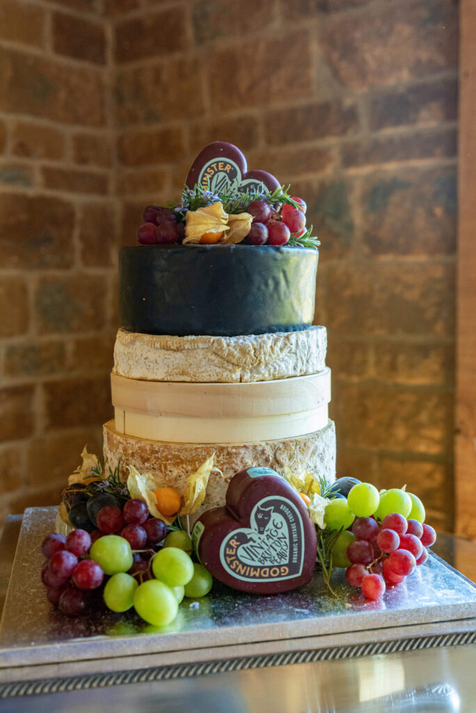 Photo of a cheese tower wedding cake on a wedding day at Dodford Manor in Northampton